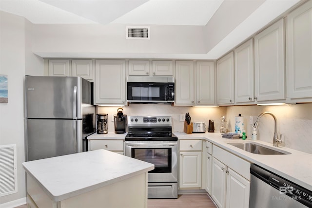 kitchen with light hardwood / wood-style floors, sink, and appliances with stainless steel finishes