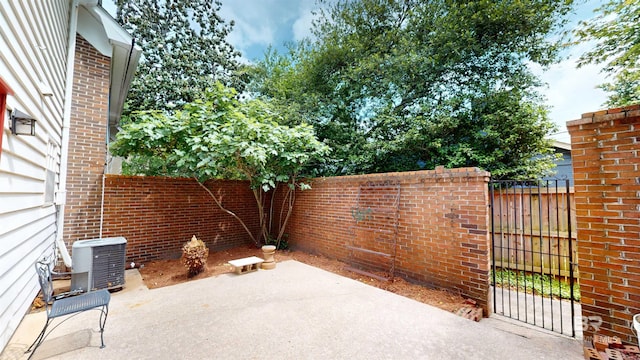 view of patio with a fenced backyard and central AC