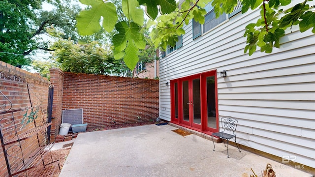 view of patio / terrace featuring fence and french doors