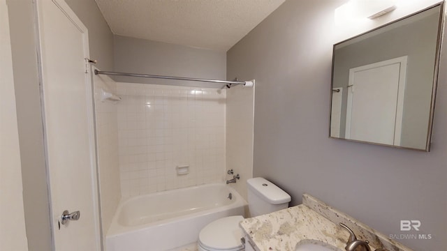 full bath with shower / bath combination, vanity, toilet, and a textured ceiling