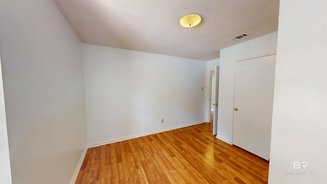 unfurnished bedroom with baseboards, visible vents, and light wood-type flooring