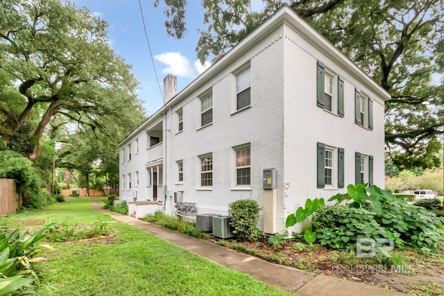 view of property exterior featuring a yard and central air condition unit