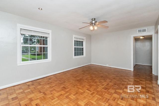 unfurnished room with parquet floors and ceiling fan