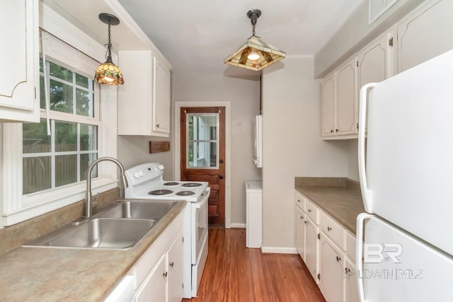 kitchen with sink, light wood-type flooring, white cabinets, hanging light fixtures, and white appliances