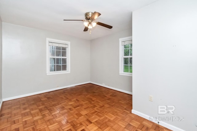 spare room with parquet flooring and ceiling fan