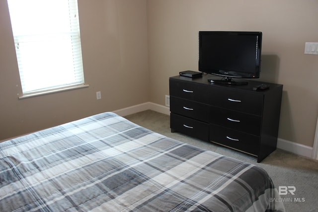 bedroom featuring light carpet