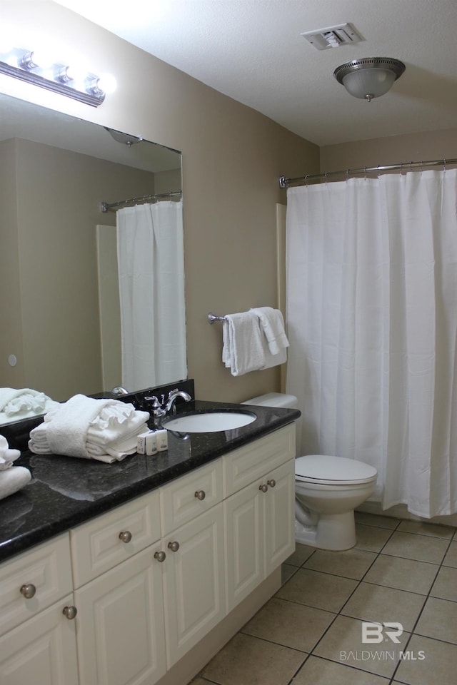 bathroom with vanity, toilet, tile patterned flooring, and a shower with shower curtain