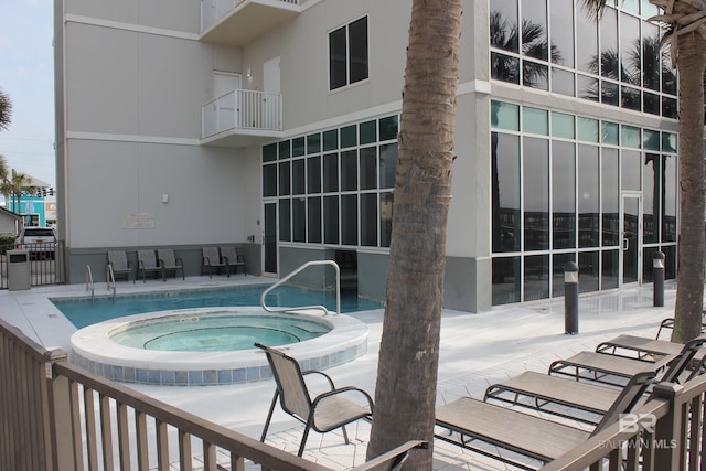 view of pool with a patio and a community hot tub