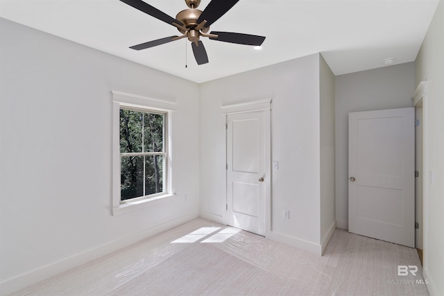 unfurnished bedroom with ceiling fan and light carpet