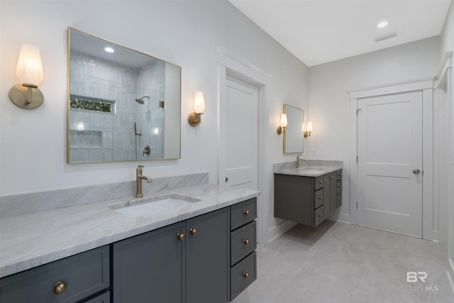 bathroom with vanity and tiled shower