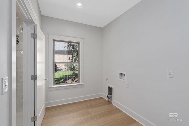 laundry area with hookup for an electric dryer, light hardwood / wood-style flooring, and hookup for a washing machine