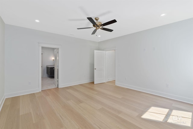 unfurnished bedroom with ensuite bathroom, light hardwood / wood-style floors, and ceiling fan