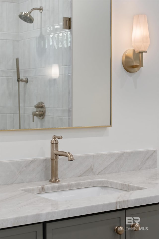 bathroom featuring vanity and a tile shower