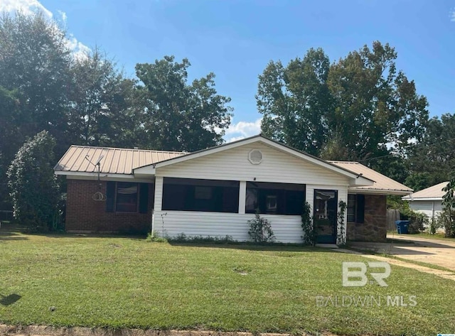 ranch-style home with a front lawn