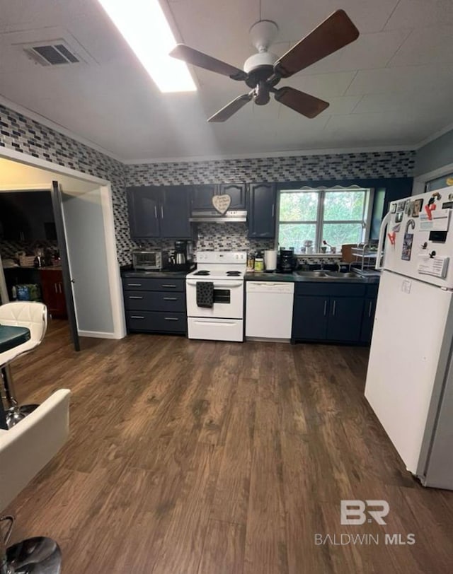 kitchen with dark hardwood / wood-style flooring, sink, white appliances, and ornamental molding