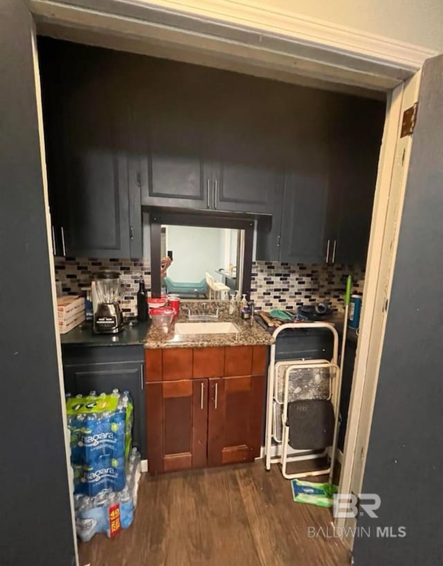 kitchen with dark hardwood / wood-style floors, sink, and decorative backsplash