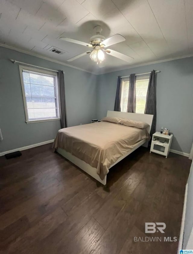 bedroom featuring crown molding, ceiling fan, and dark wood-type flooring