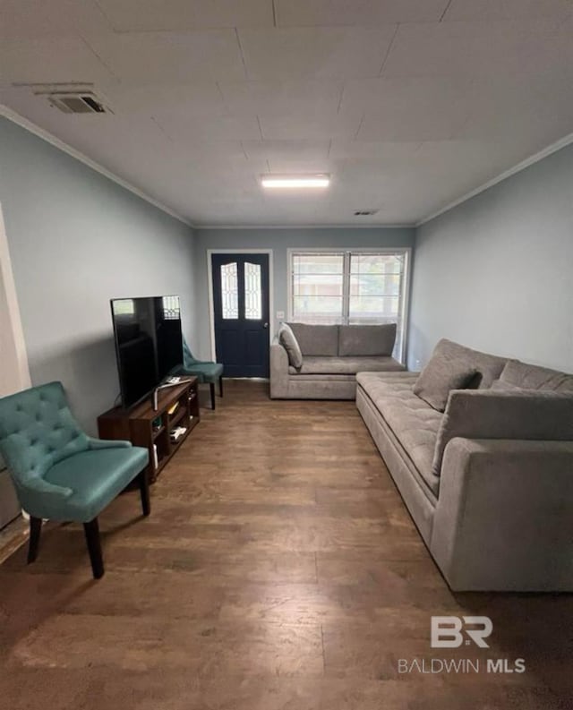 living room with hardwood / wood-style floors and crown molding