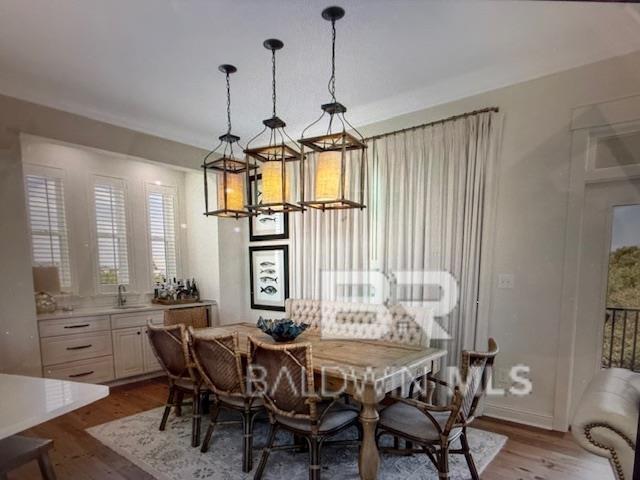 dining area with wood finished floors