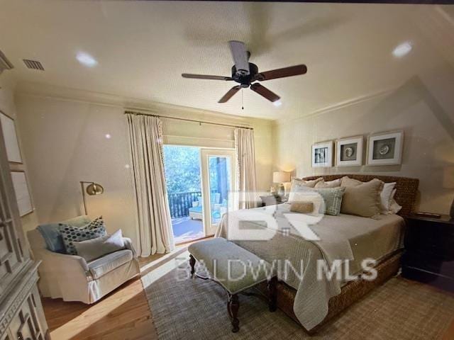 bedroom featuring wood finished floors, visible vents, ceiling fan, crown molding, and access to outside