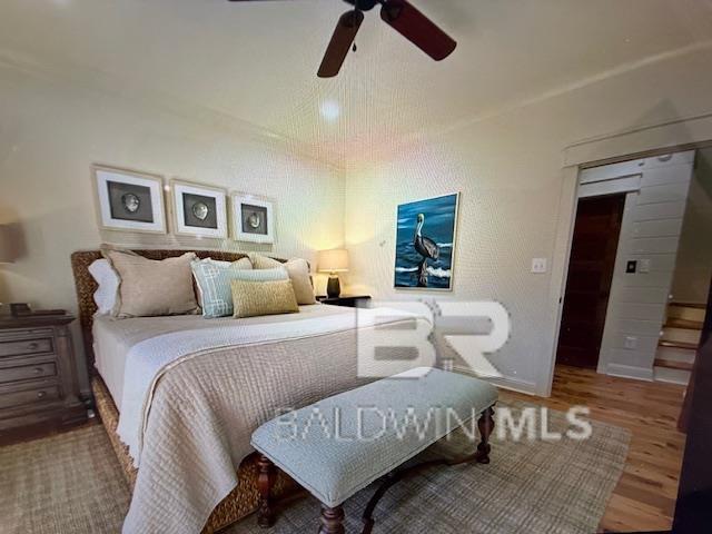 bedroom featuring a ceiling fan and wood finished floors