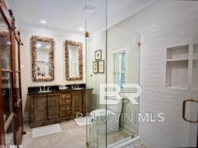 bathroom with double vanity, recessed lighting, a stall shower, a sink, and ornamental molding