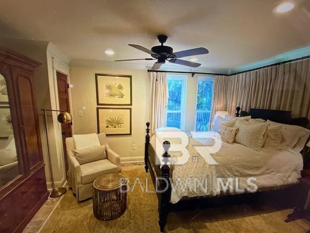 bedroom featuring a ceiling fan and baseboards