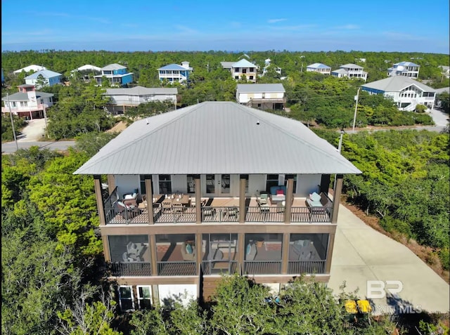 exterior space with metal roof and a balcony