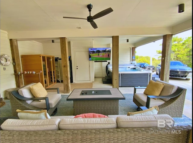 view of patio / terrace with ceiling fan, an outdoor hangout area, and a hot tub