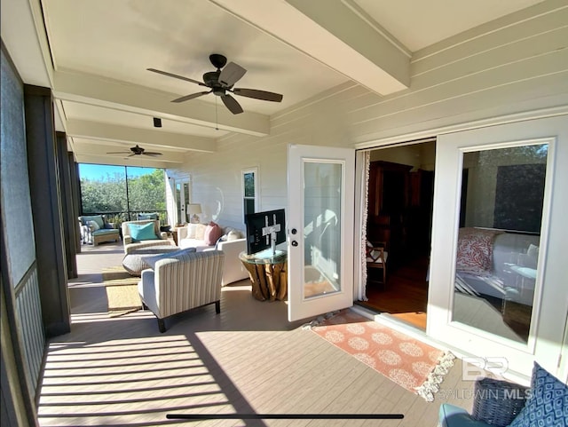 sunroom / solarium featuring beam ceiling