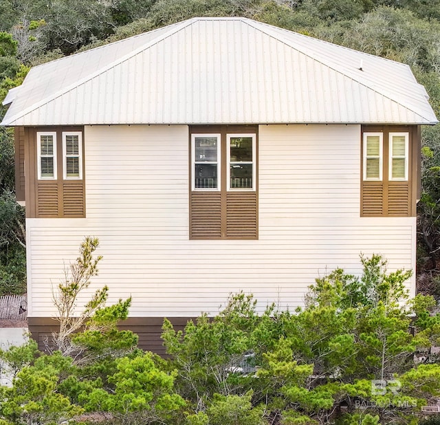 view of side of home with metal roof