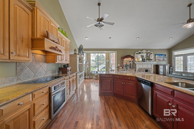 kitchen featuring ceiling fan, appliances with stainless steel finishes, and lofted ceiling