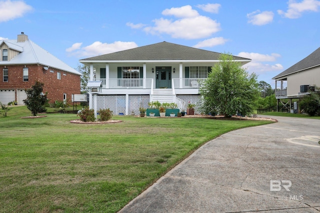 view of front of home with a garage, a front lawn, central AC, and covered porch