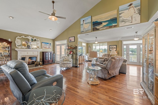 living room with high vaulted ceiling, ceiling fan, hardwood / wood-style flooring, and crown molding