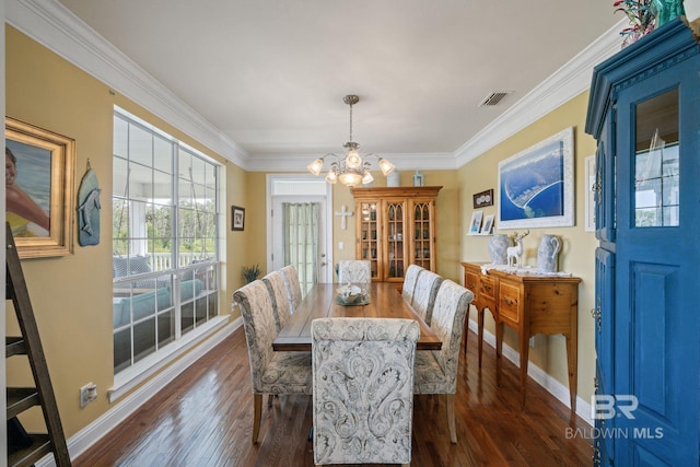 dining space with ornamental molding, a notable chandelier, and dark hardwood / wood-style flooring