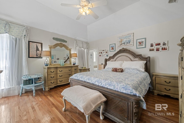 bedroom with wood-type flooring, lofted ceiling, and ceiling fan