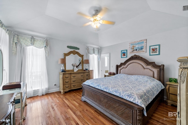 16288 Ferry Rd, Fairhope, AL 36532 - bedroom featuring a ceiling fan, visible vents, a raised ceiling, baseboards, and light wood-style floors