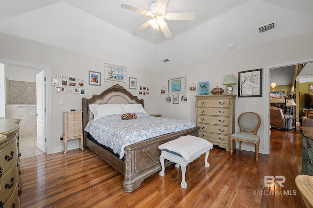 bedroom with lofted ceiling, ensuite bath, ceiling fan, and dark hardwood / wood-style flooring