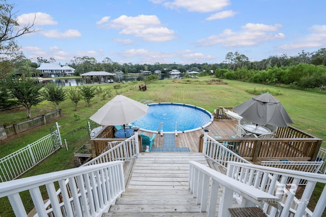 16288 Ferry Rd, Fairhope, AL 36532 - view of swimming pool featuring a lawn, fence, and a wooden deck