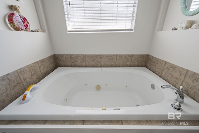 bathroom featuring a bathing tub and a healthy amount of sunlight