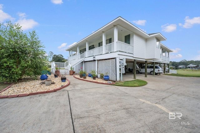 view of front facade with a porch and a carport