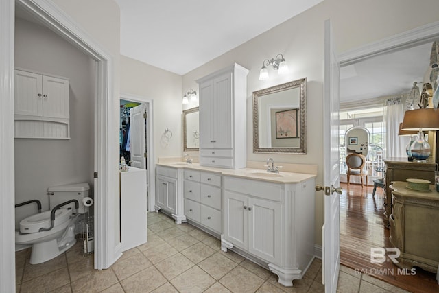 bathroom with hardwood / wood-style flooring, vanity, and toilet