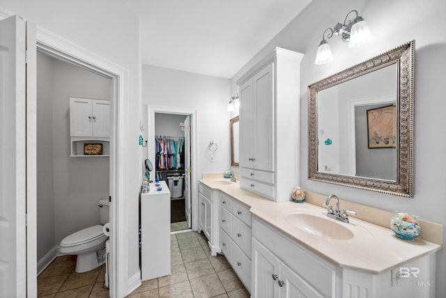16288 Ferry Rd, Fairhope, AL 36532 - bathroom featuring double vanity, a sink, tile patterned floors, baseboards, and toilet