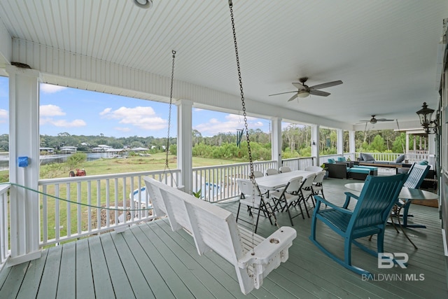 deck featuring ceiling fan and a yard