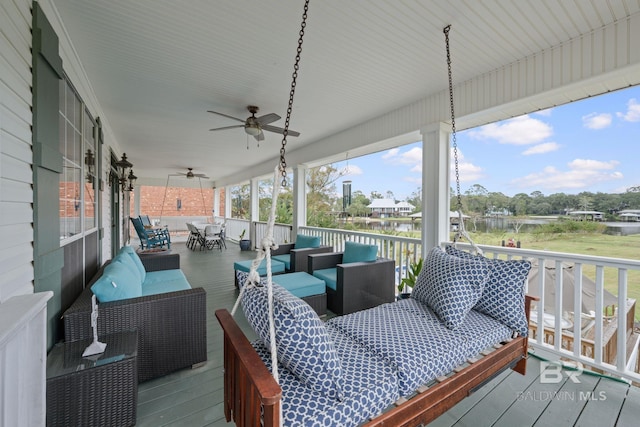 wooden deck featuring outdoor lounge area and ceiling fan