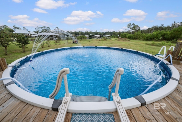 view of swimming pool featuring a lawn