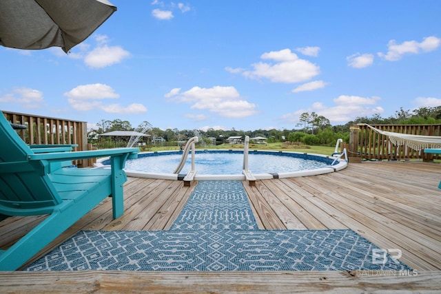 view of swimming pool featuring a deck