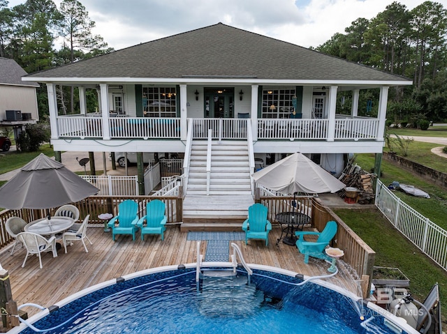 rear view of property with a swimming pool side deck