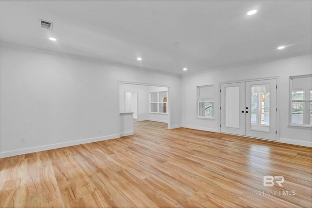 interior space with light wood finished floors, visible vents, and recessed lighting