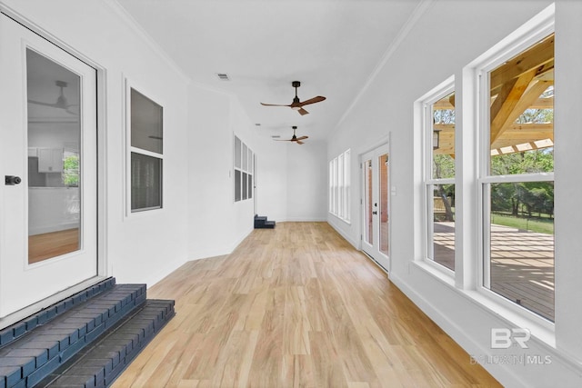 sunroom / solarium with french doors, ornamental molding, baseboards, visible vents, and wood finished floors